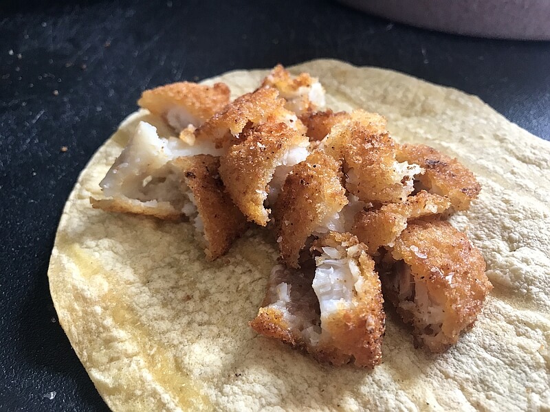 One or two Fish Sticks cut or broken up into small pieces, and laid on a warm tortilla.