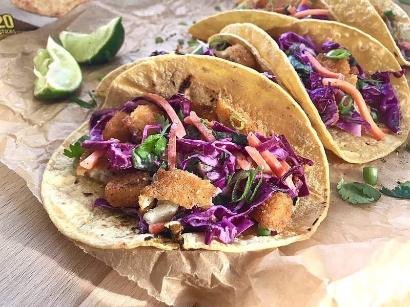 An irresistible picture of ready-to-eat Gorton's Fish Stick Tacos, topped with crunchy slaw.