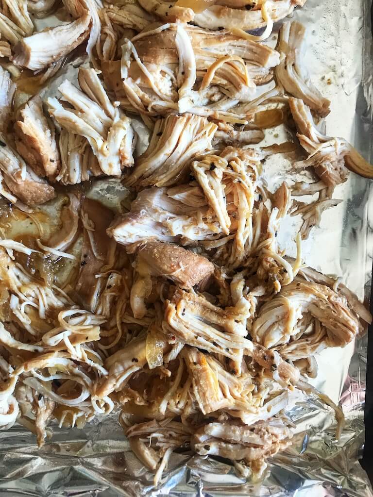 chicken lightly shredded on a sheet pan