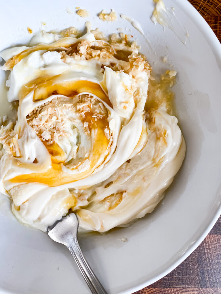 light mayo, minced onion, honey, and greek yogurt in a bowl
