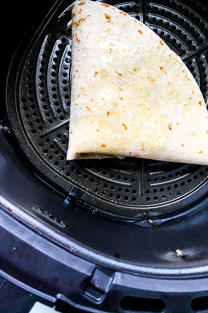 taco crunchwrap on the air fryer grate