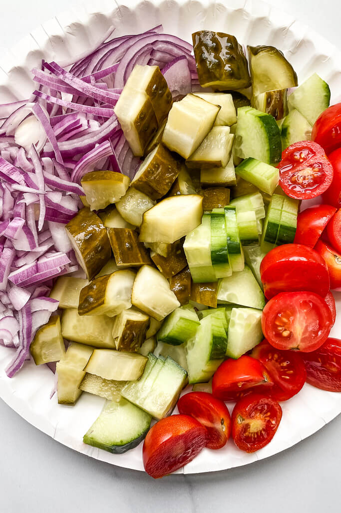 thinly sliced red onion, diced pickles, cucumber, and red tomatoes