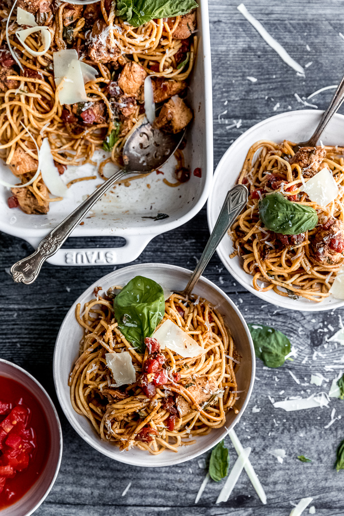 two bowls of bruschetta chicken spaghetti with basil