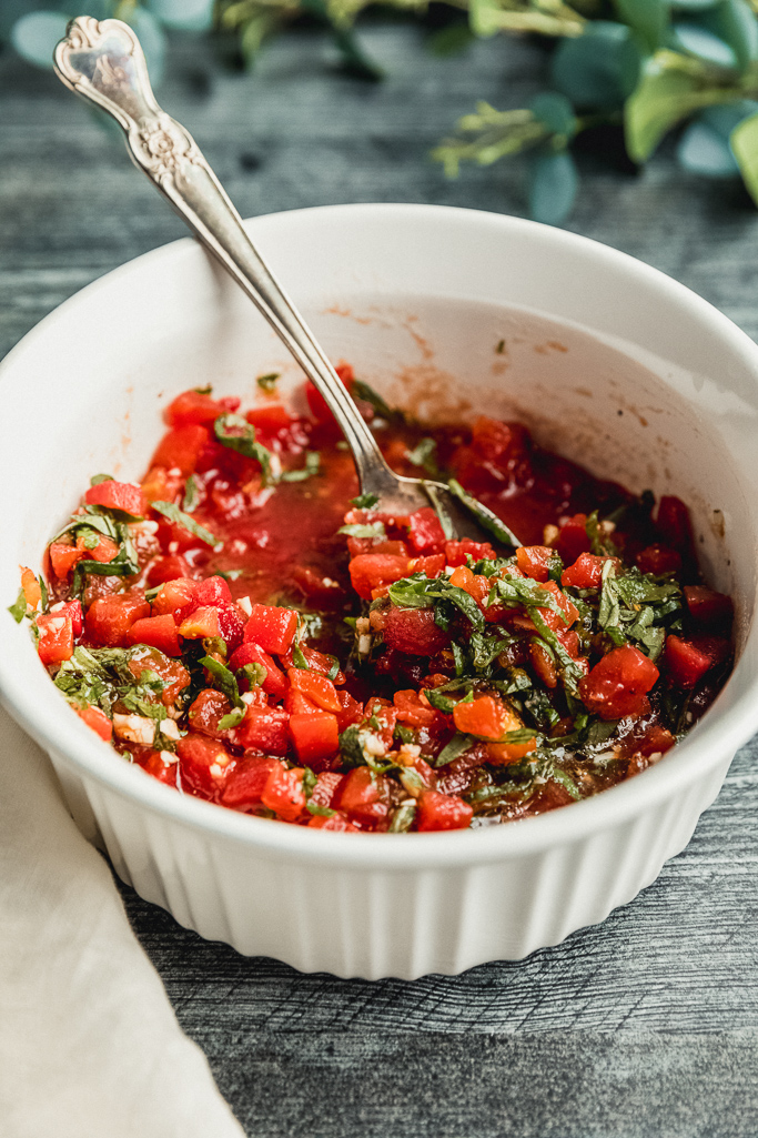 bowl with tomatoes and basil stirred together