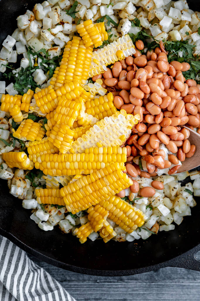 skillet with pinto beans and fresh corn