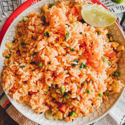 Instant Pot Mexican Rice in bowl with linmes on the side