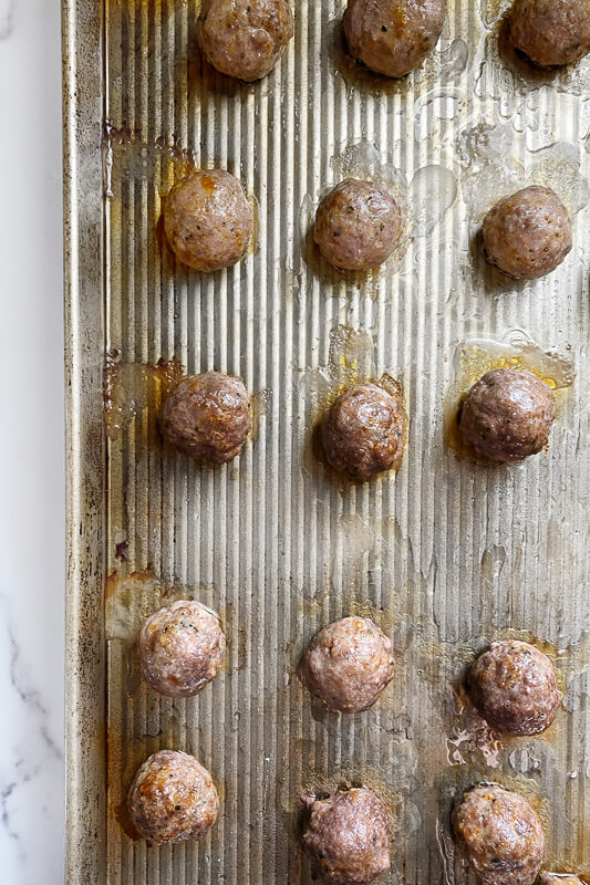 cooked Greek Meatballs on a sheet pan 