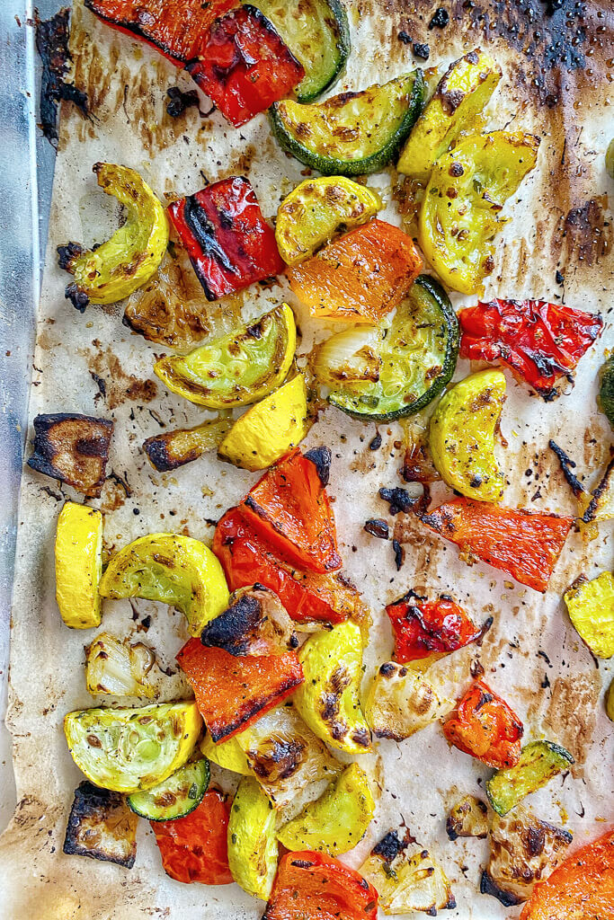 roasted zucchini, yellow squash, onion, red bell pepper on a sheet pan- Greek Roasted Vegetables 