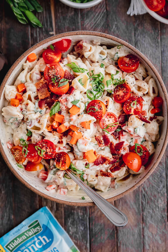bowl of BLT Pasta Salad with tomatoes and green onions