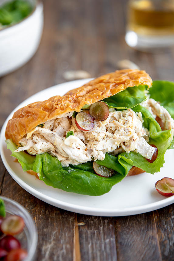healthy chicken salad on a whole grain bun with lettuce and grapes