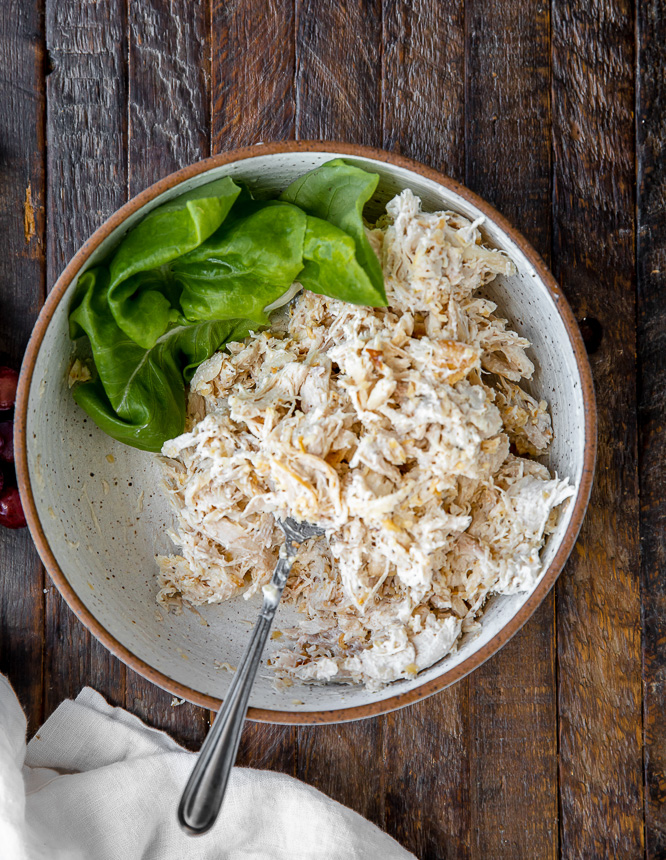 easy and healthy chicken salad in a bowl with lettuce and spoon
