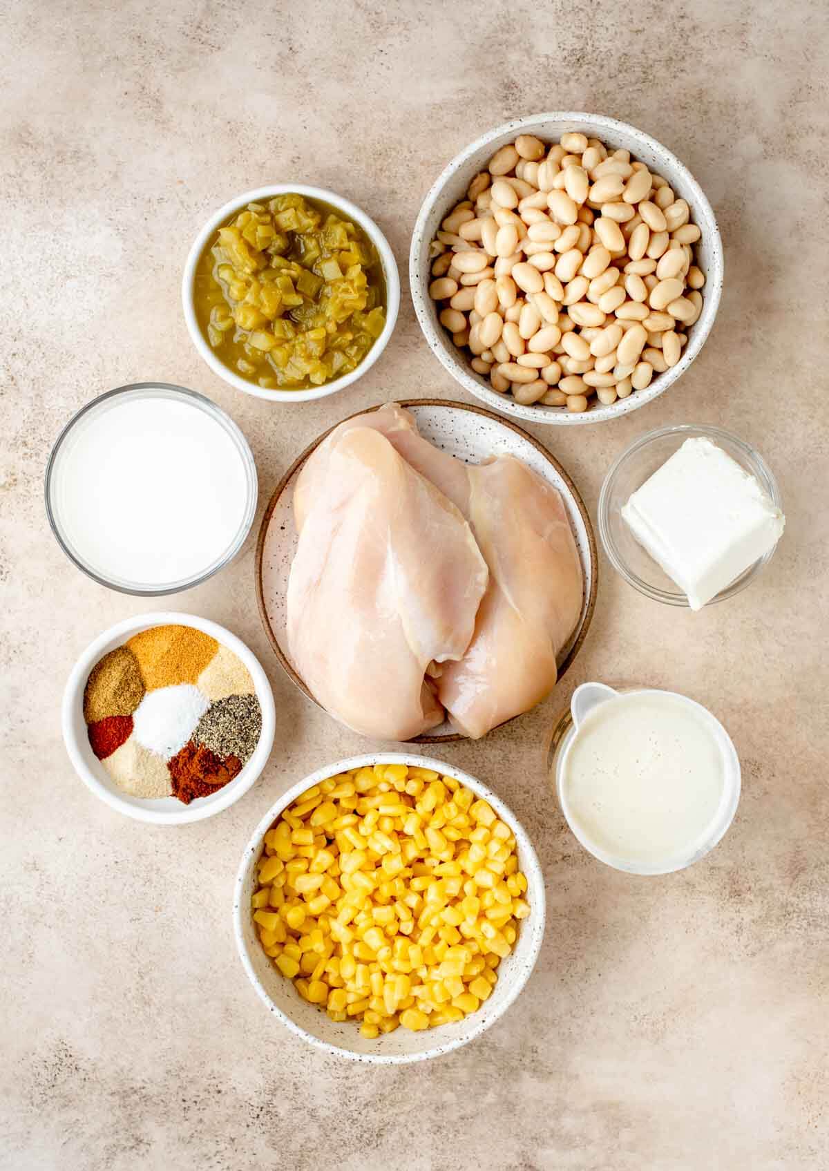 ingredients: canned Green Chiles, great Northern beans, cream cheese, broth, corn, spices, raw chicken, Half and half