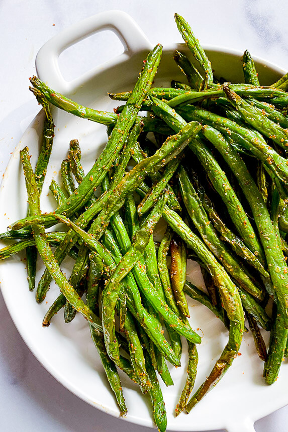 cooked green beans on a white plate