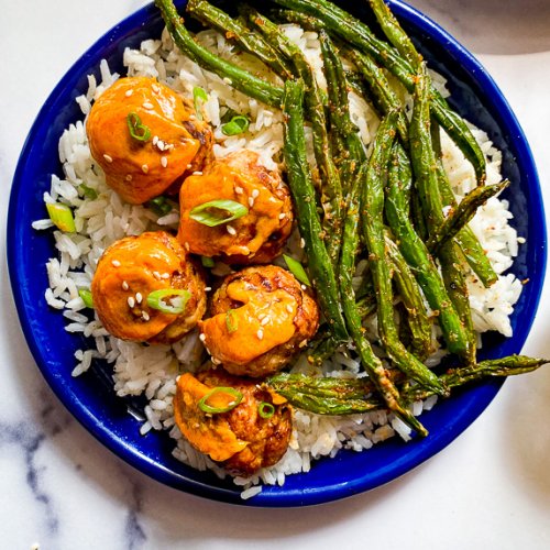 meatballs on blue plate with rice and green beans