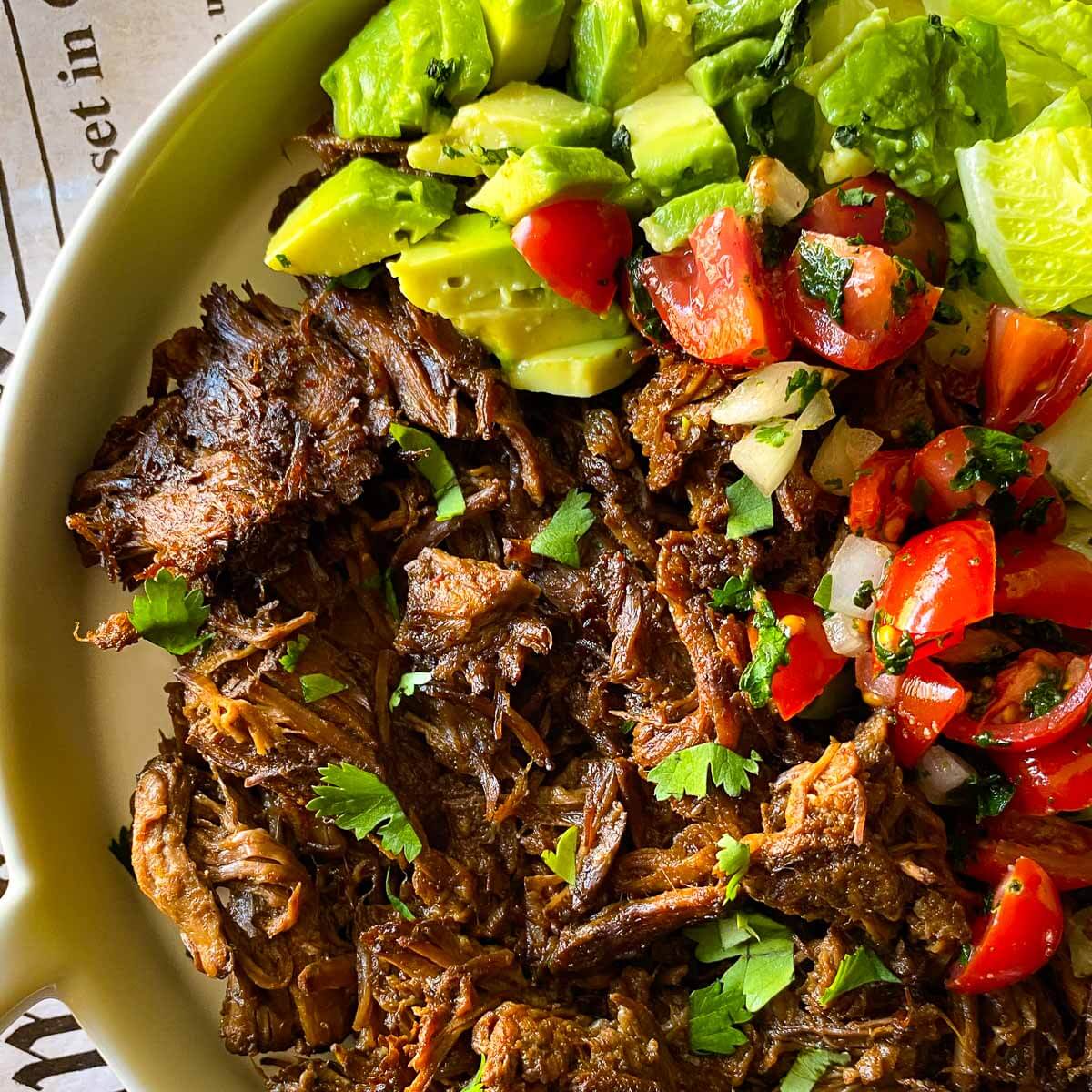 shredded Mexican beef on plate with Pico De Gallo and lettuce