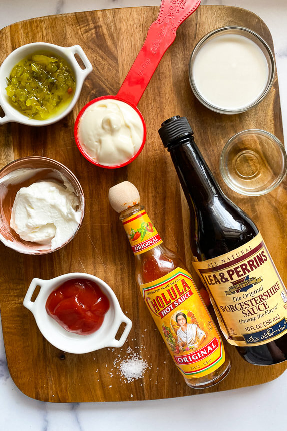 ingredients: a bottle of hot sauce and worsestershire sauce, small bowls of ketchup, non fat Greek yogurt, mayo, sweet relish, milk, and apple cider vinegar