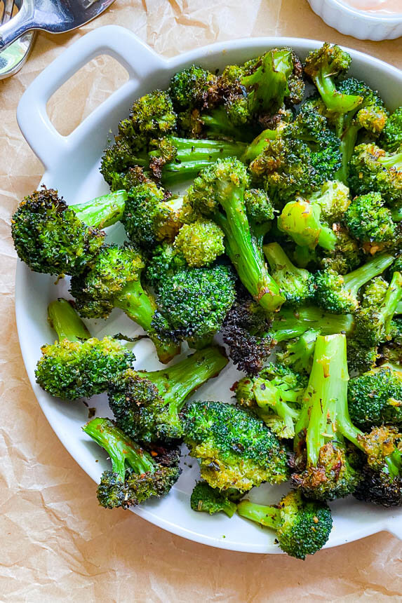 plate of broccoli fresh from the air fryer with golden crispy edges
