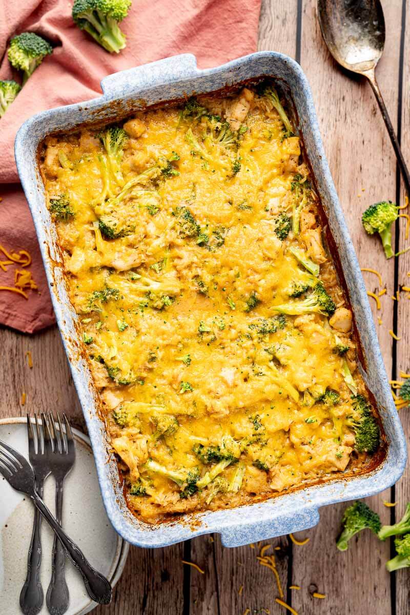 baked chicken and rice casserole with broccoli and melted cheese in a baking dish