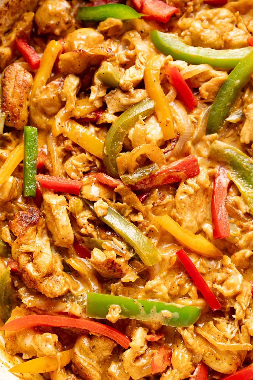 close up of philly chicken filling with sliced chicken, red and green peppers
