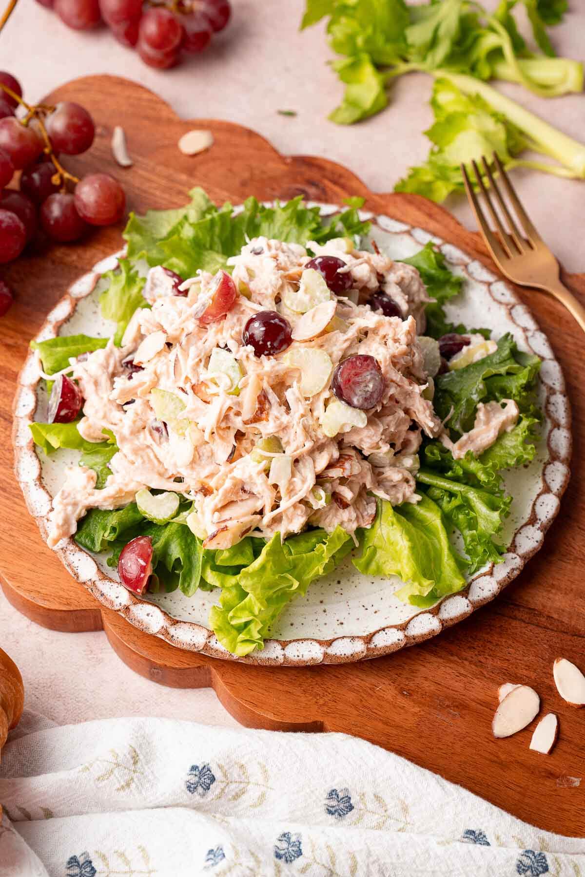 plate with lettuce and amound of chicken salad 
