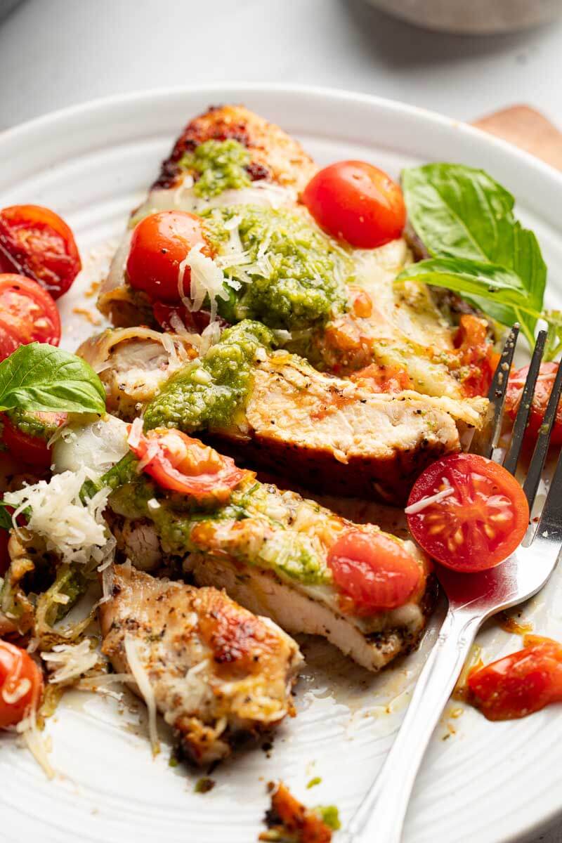 sliced grilled chicken margherita with pesto mozzarella and cherry tomatoes