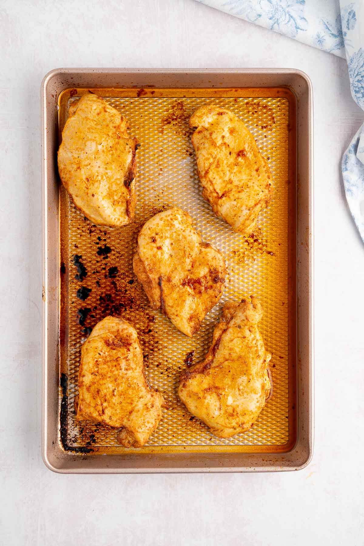 baked chicken on sheet pan resting
