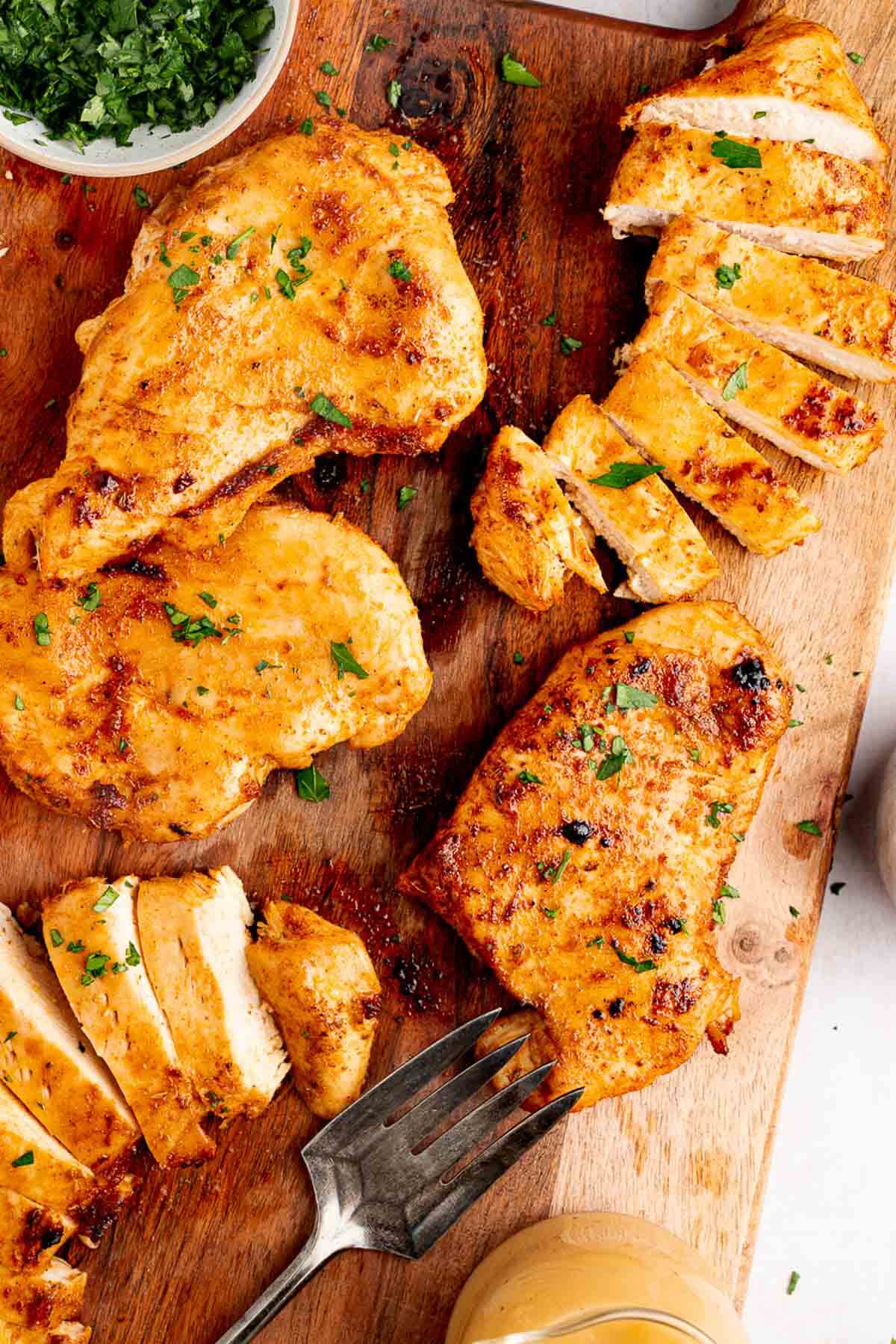oven baked chicken on cutting board sliced