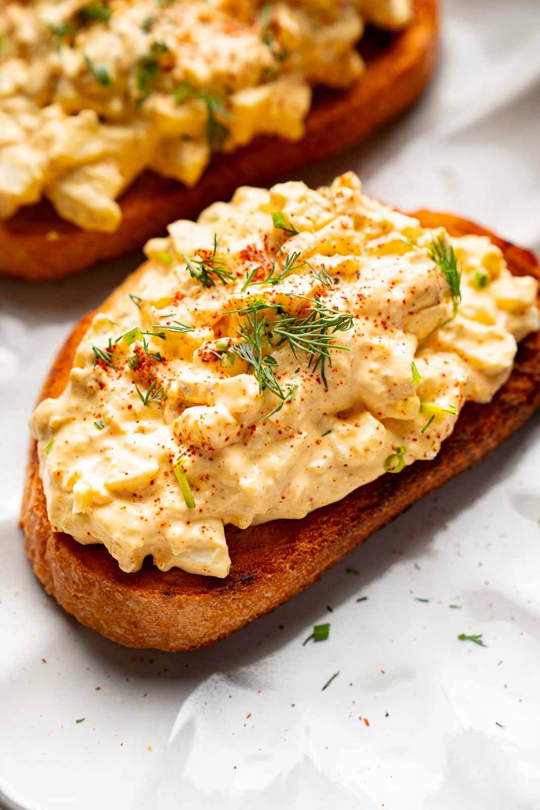cottage cheese egg salad on toast with dill garnished on top