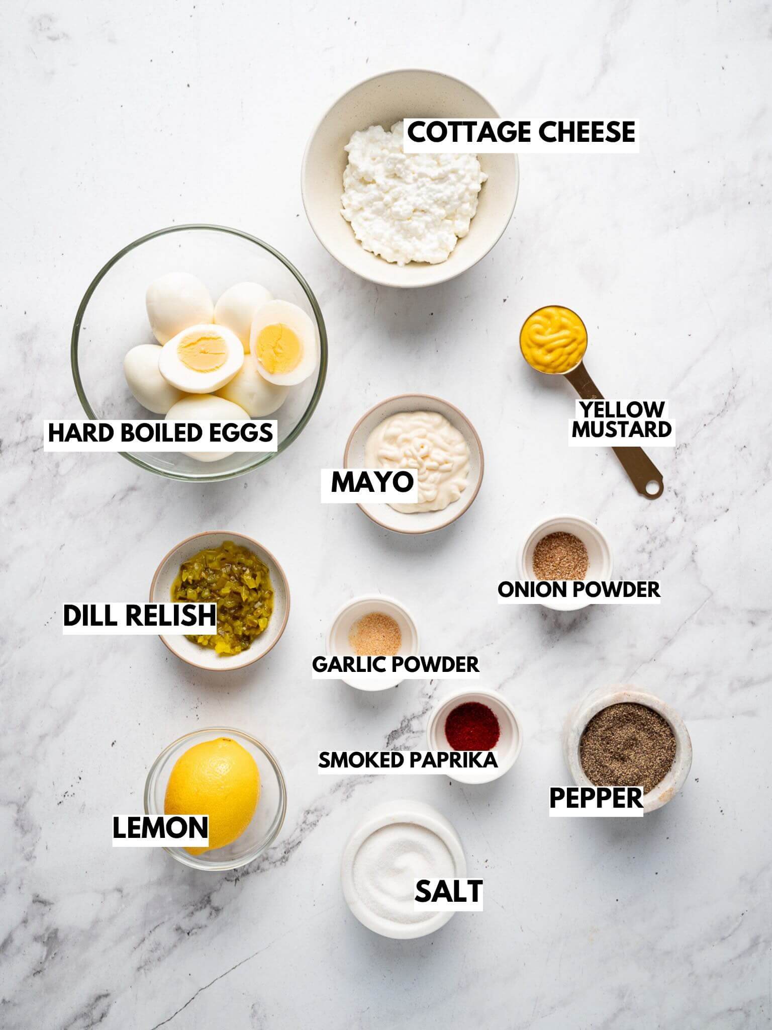 Ingredients for cottage cheese egg salad with eggs, cottage cheese, mayo, mustard, dill relish, lemon, and seasonings.