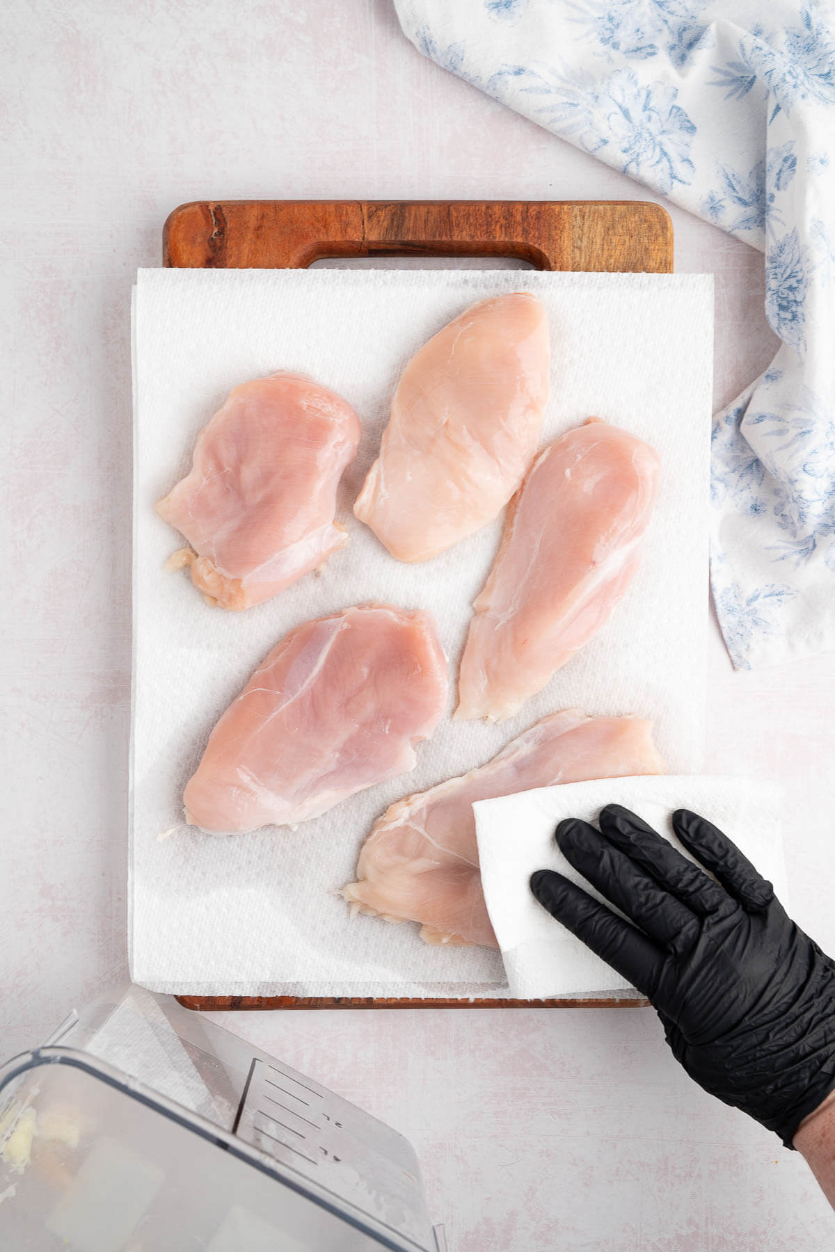 patting chicken breast dry with paper towel
