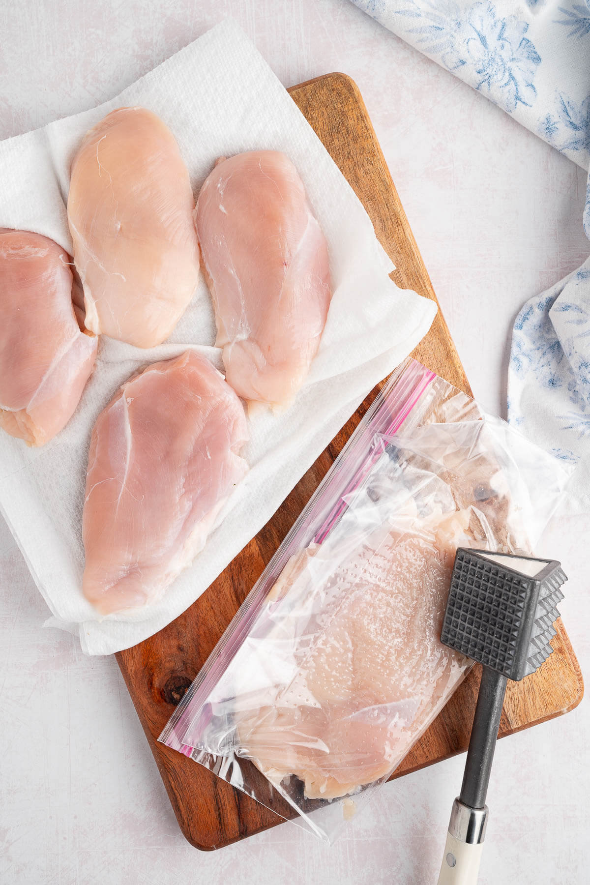pounding chicken breast with meat mallet