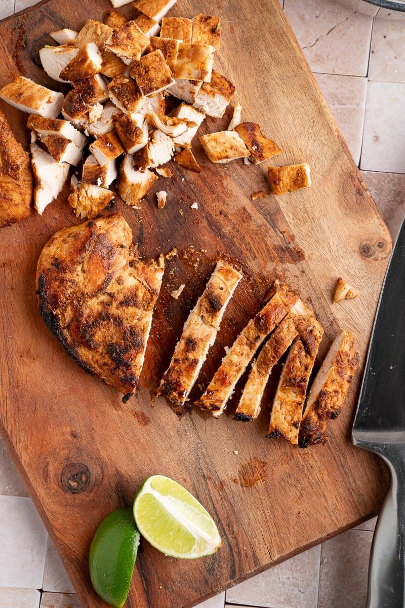 chipotle chicken being diced on a cutting board