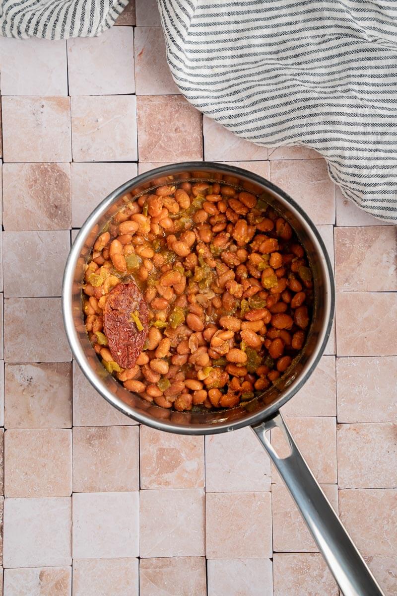 pinto beans simmering in a pot 