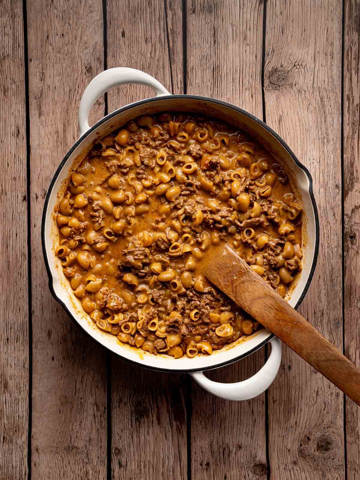 homemade hamburger helper being stirred together to thicken the sauce.
