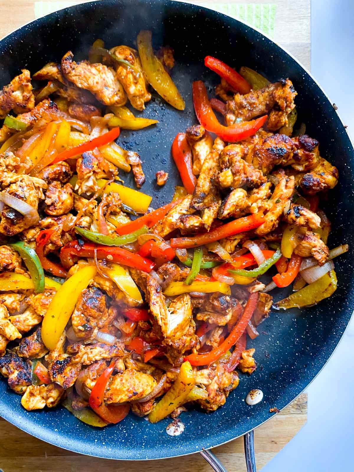 chicken fajitas in skillet.