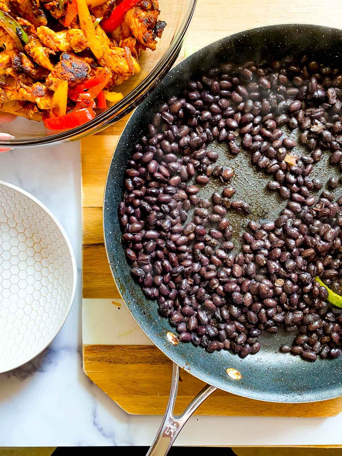 black beans and spices in a skillet.