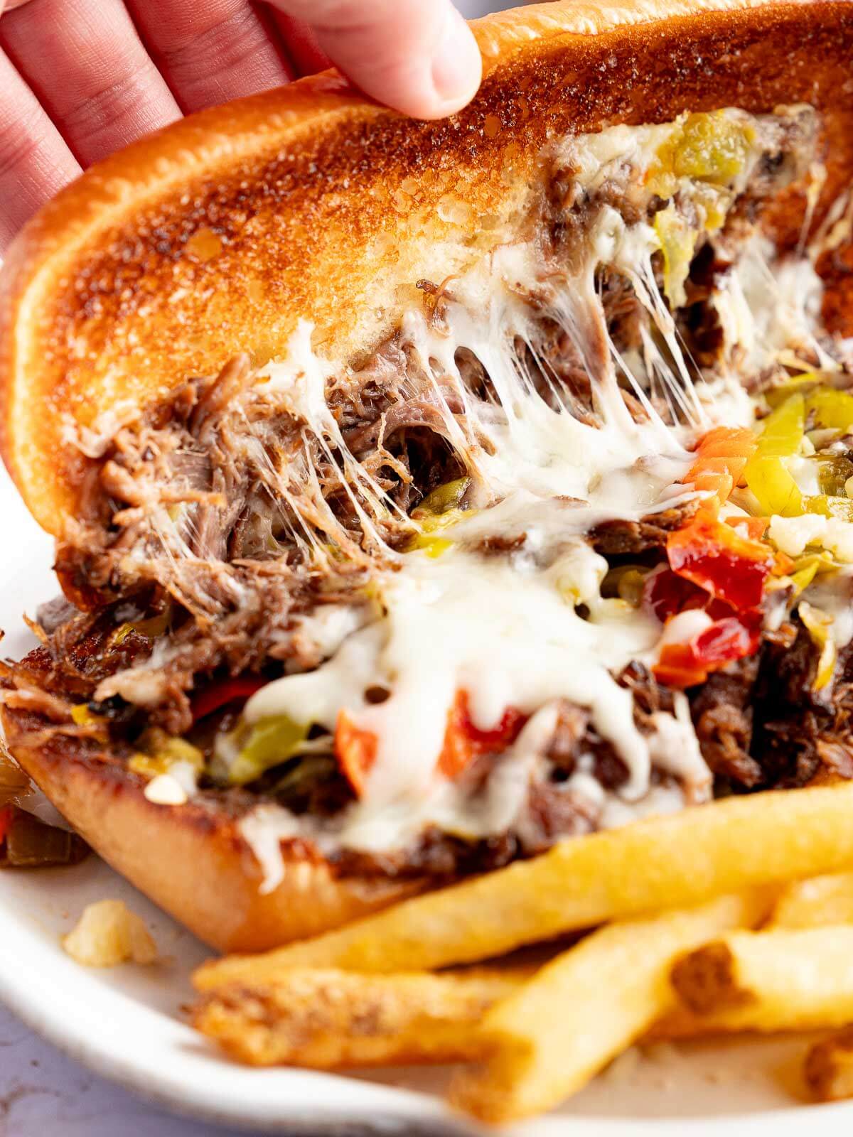 italian beef sandwich with melty mozzarella cheese and chicago style giardiniera.