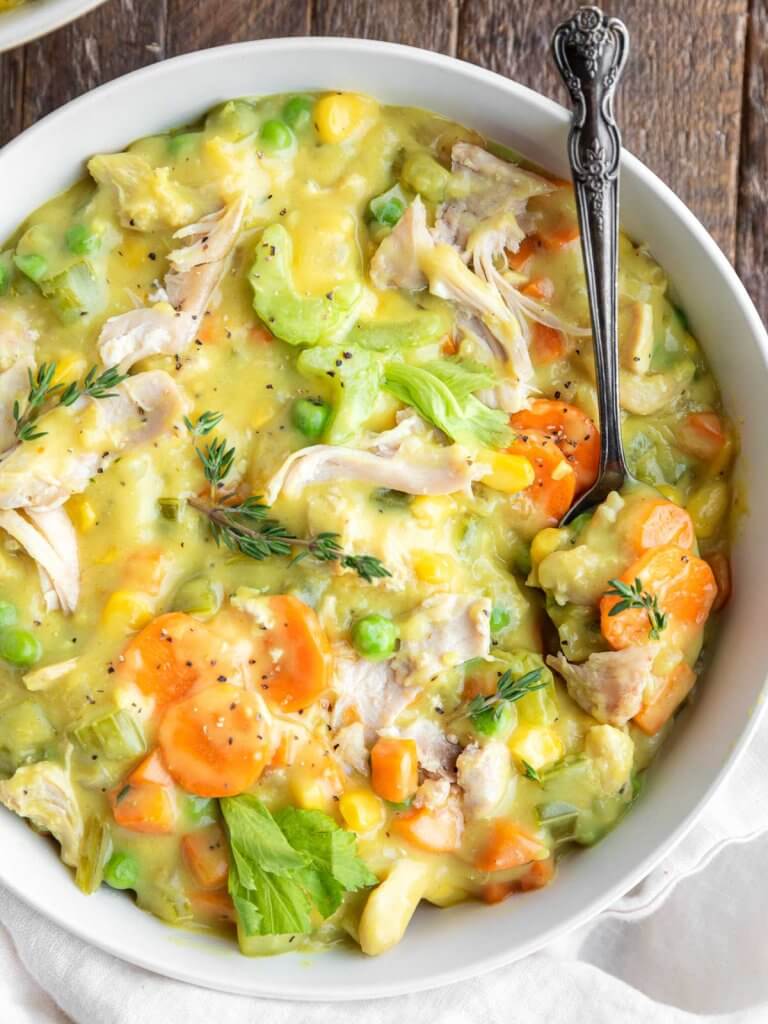 bowl of creamy chicken pot pie soup with celery, carrots, and shredded chicken.
