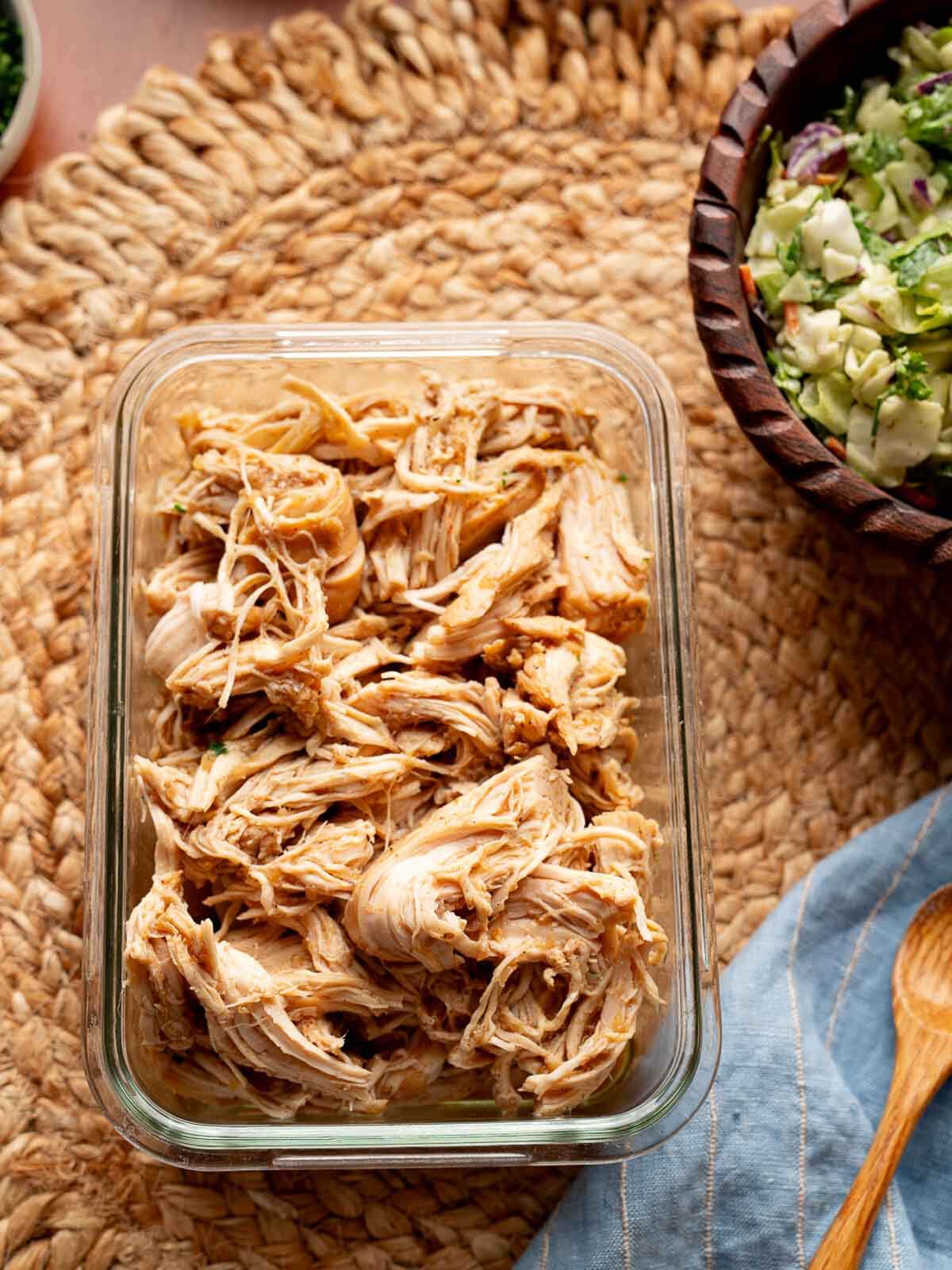 crockpot shredded chicken in a storage container.