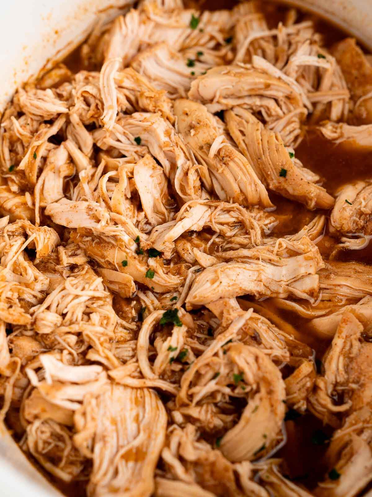 crockpot shredded chicken inside slow cooker.