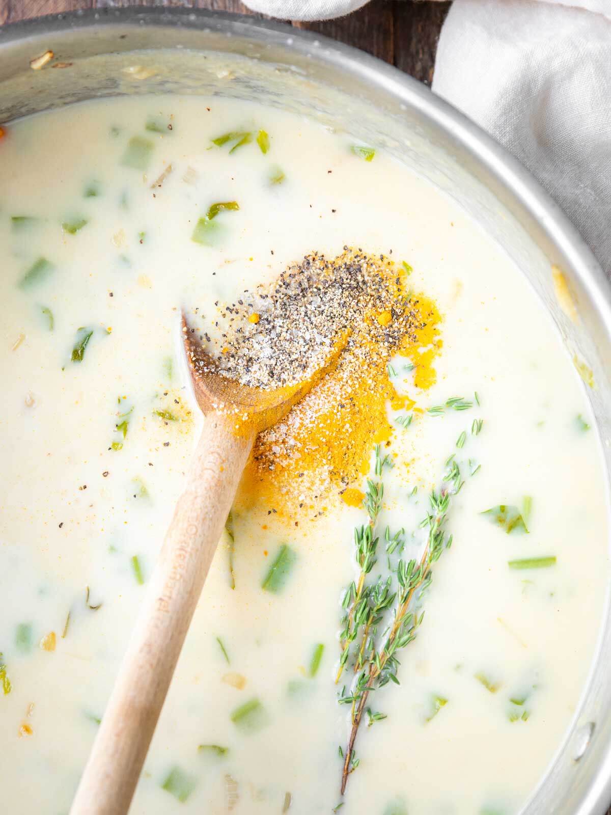 Thyme, turmeric, salt, and pepper added to the creamy soup base.