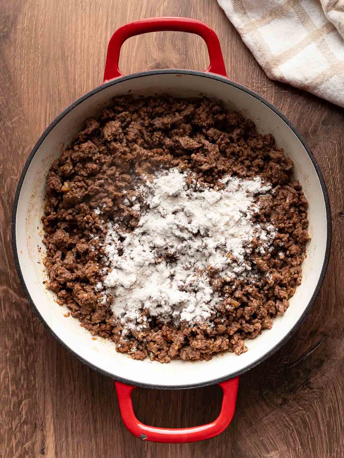 browned ground beef with flour on top.