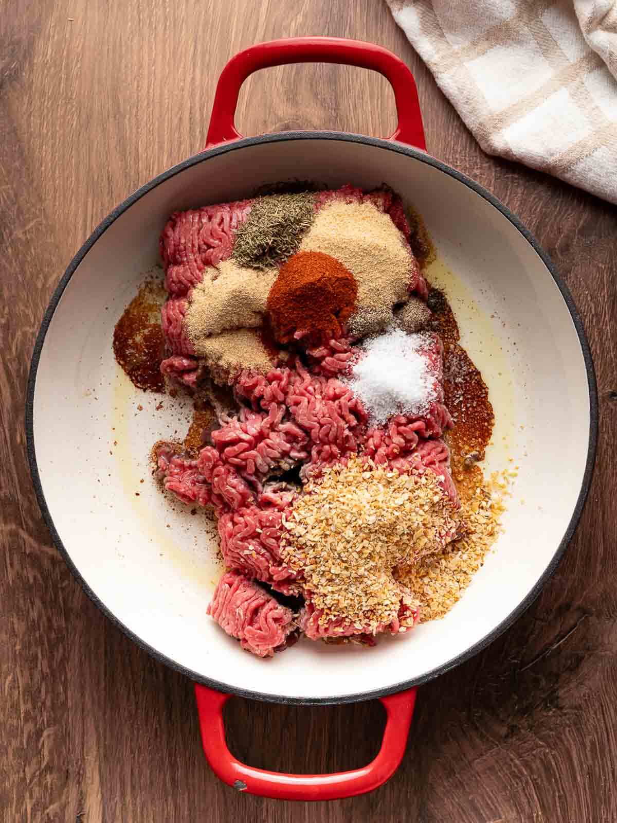 ground beef in skillet with spices and dried minced onion.